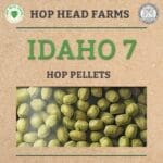 A close-up image of Idaho 7 hop pellets in a bag, with the logos of Hop Head Farms and the Michigan Department of Agriculture on the corners of the label. Text reads: "Idaho 7 Hop Pellets.